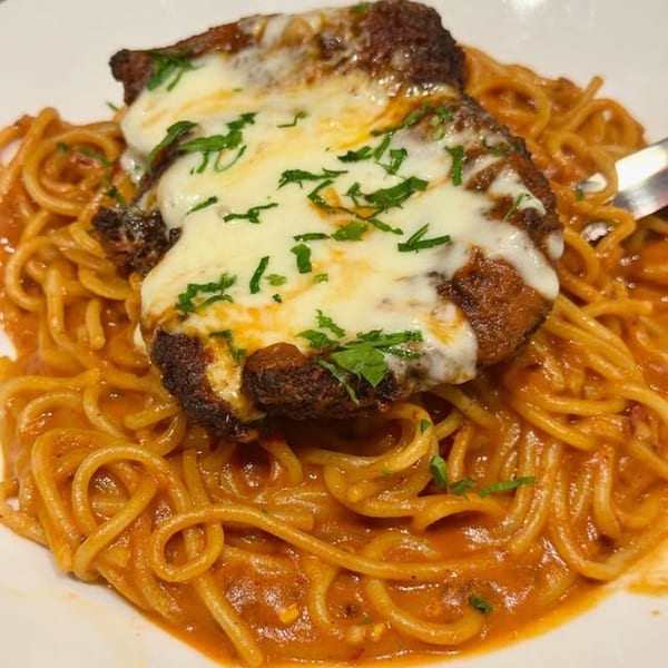 Harvey's American spaghetti dish with a breaded cutlet topped with melted cheese and parsley.
